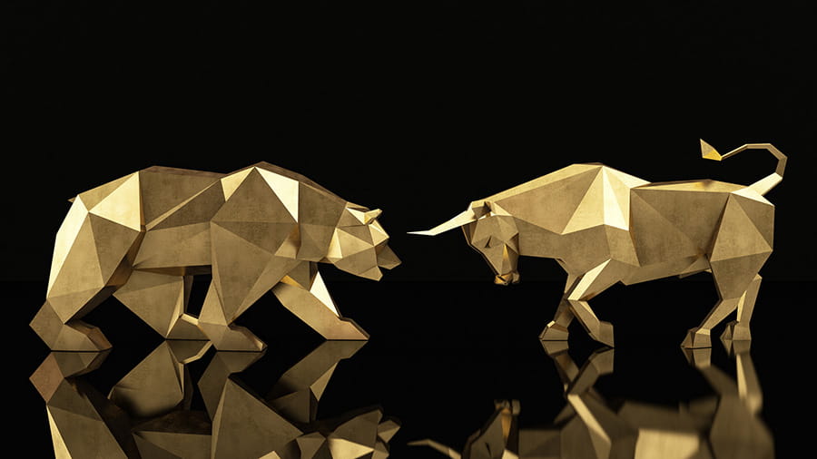 A gold bear going head to head with a gold bull symbolizing the ongoing battle of rising and falling stocks.