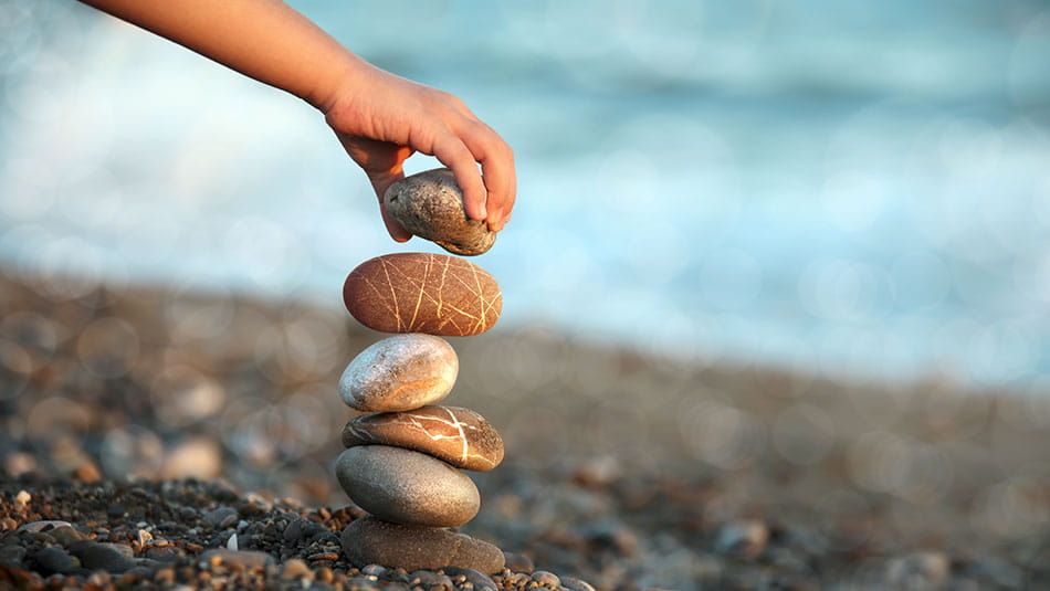 Hand balancing rocks