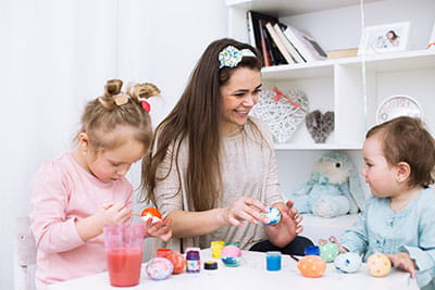Photo of mom crafting with daughters