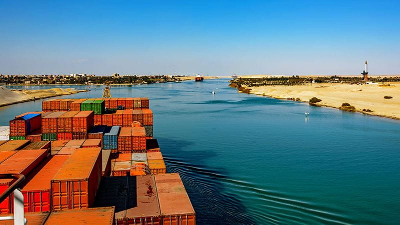 Cargo ship navigating the Suez Canal.