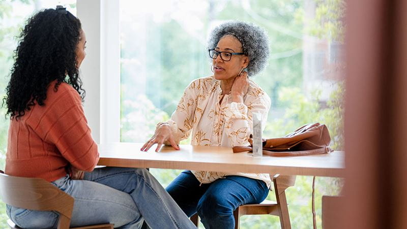 Mother and daughter having a conversation about finances