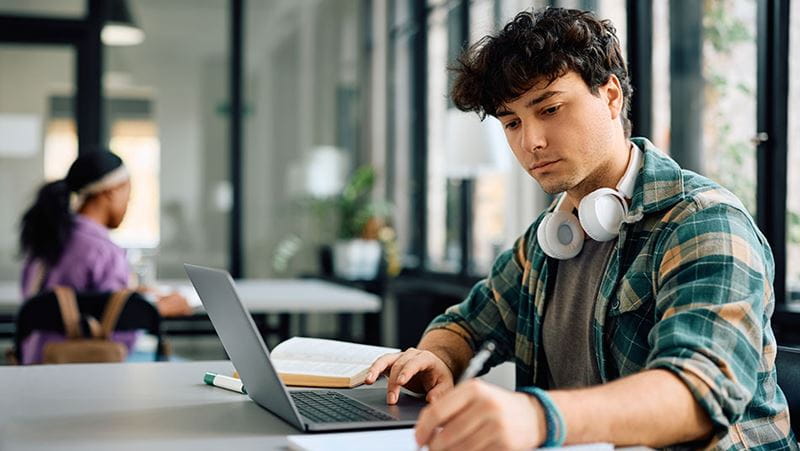 College student working on homework in the library