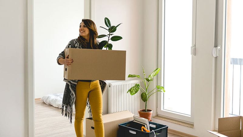 Una mujer mudándose a un nuevo hogar